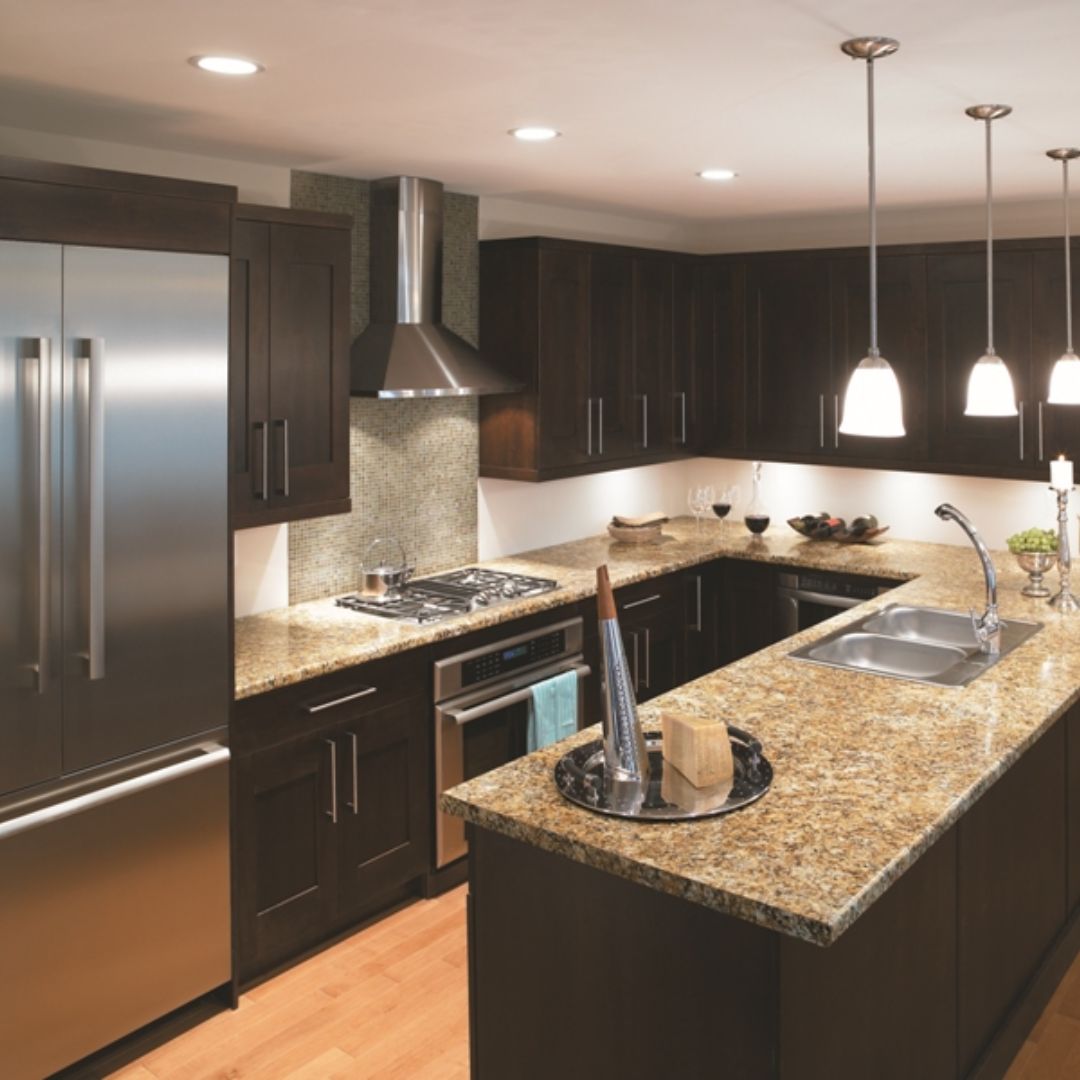 Modern remodeled Bay Area kitchen with dark cabinets and granite countertops showing layout-first approach