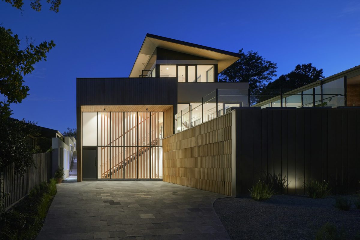 Modern garage-scale structure with dark cladding converted to living space