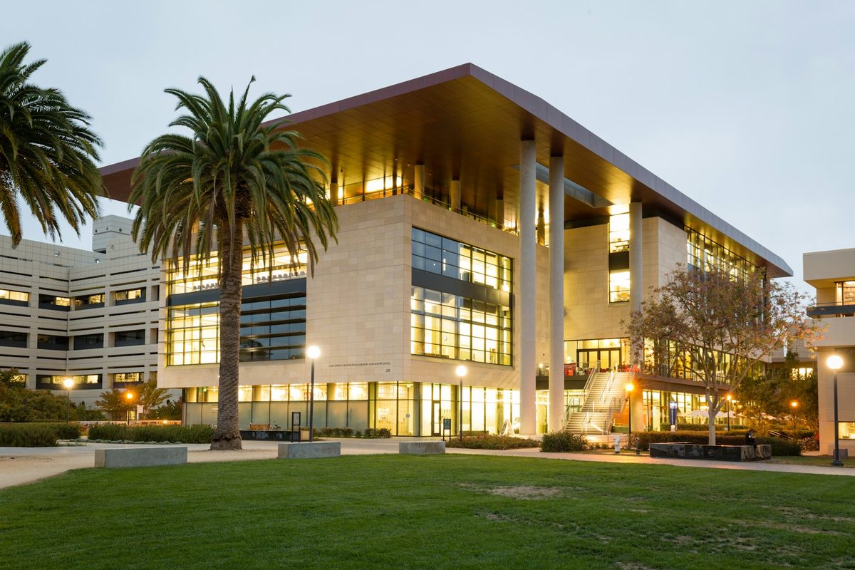 Stanford University campus architecture with palm trees at dusk in Palo Alto